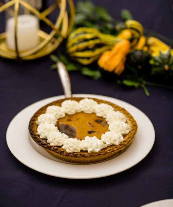 dessert plate with pumpkin pie and decorative gourds