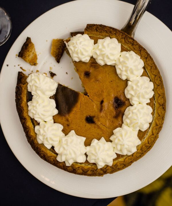 pumpkin pie with dollops of whipped cream